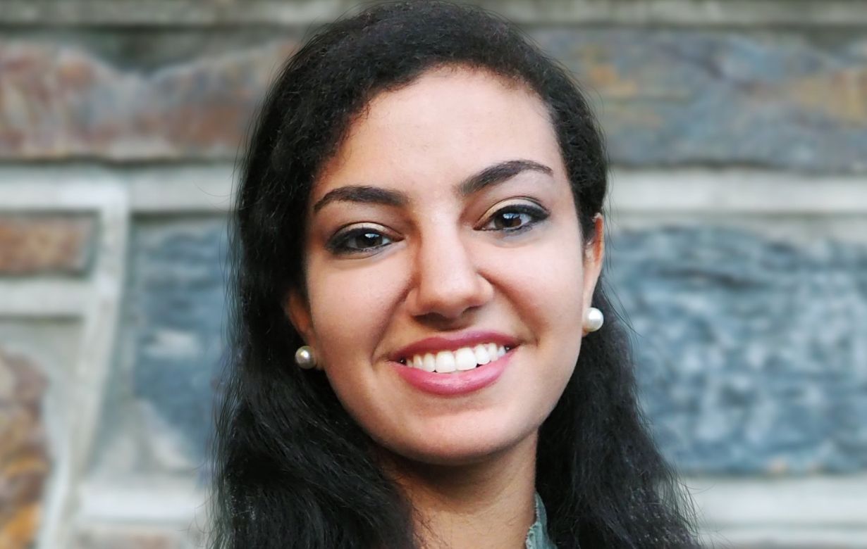 Close up image of a young woman named Angela Tawfik smiling at the camera
